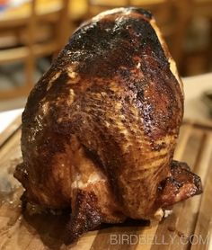 a large piece of meat sitting on top of a wooden cutting board