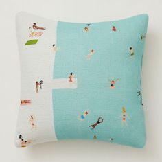 a pillow with people on the beach printed on it