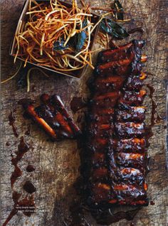 barbecue ribs and sauteed greens on a cutting board