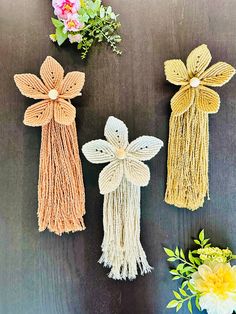 three crocheted bows and flowers on a table