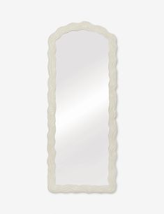 an ornate white mirror on a wall