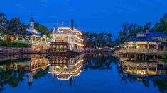 a boat is docked in the water at night with lights on it's sides