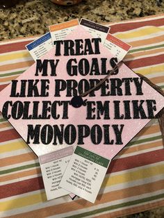 a graduation cap that says treat my goals like property collect'em like monopoly