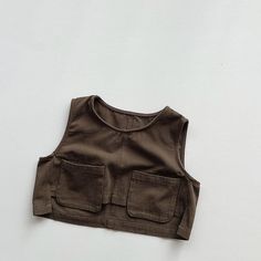 This vintage casual vest is perfect for keeping your child cozy during the spring and autumn. It is made of high-quality cotton and worsted fabric and has a comfortable O-neck design. The vest is also easy to care for, and it can be machine washed and dried. Features: Thick, warm fabric Casual style Solid color O-neck design Easy to care for Specifications: Material: Cotton, worsted Gender: Unisex Age range: Children Fit: Fits true to size Season: Spring, autumn Pattern: Solid Outerwear Type: Ve Sleeveless Cotton Denim Vest With Pockets, Casual Brown Tank Vest, Sleeveless Tops With Pockets For Everyday, Cotton Vest With Pockets For Fall, Khaki Cotton Tank Top, Casual Cotton Sleeveless Vest, Khaki Cotton Sleeveless Tank Top, Cotton Sleeveless Sweater Vest For Fall, Khaki Sleeveless Cotton Tank Top