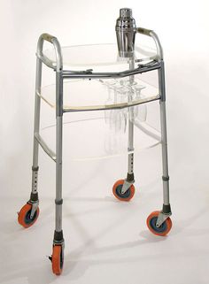 a medical walker with wheels and an orange handle