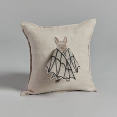 a pillow with a bat embroidered on it