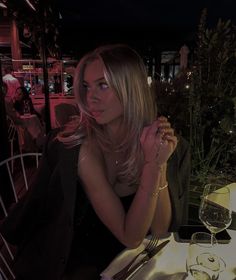 a woman sitting at a table in a restaurant