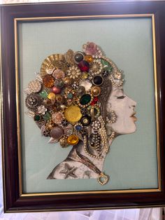 a woman's head is surrounded by buttons and other items in a framed frame