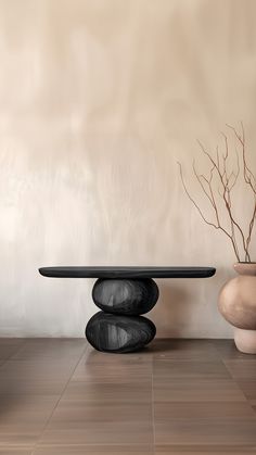 two vases and a table on the floor in front of a wall with a plant