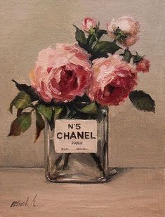 a painting of pink roses in a glass vase with chanel no 5 label on it