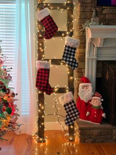 christmas stockings hanging from a ladder in front of a fireplace