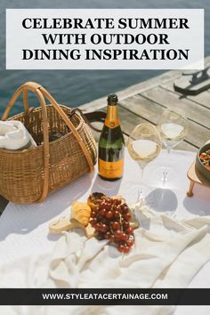 a picnic table with food and wine on it