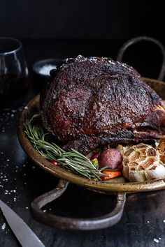 a roast beef on a platter with vegetables and meat in the center, ready to be eaten