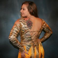 will fit size 5/6-9/10, stretchy Crafted from lustrous gold-hued hologram tiger print metallic lycra, this Latin-rhythm dress features lattice strapping on the long sleeves, bodice, & low cut back. Several skirt panels combine with vertical chainette fringe in gold & yellow tones to capture all your dynamic Latin-rhythm moves. As you show off your passionate motion & spins, you'll look and feel fiercely fabulous! Many variations can be custom made especially for you, in other colors, fabrics, & Rhythm Dress, Gold Tiger, Latin Dress, Dress With Long Sleeves, Yellow Tones, Tiger Print, Gold Yellow, Low Cut, 9 And 10