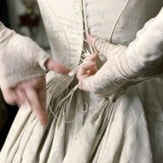 a woman in a white dress is holding on to her hand with an inscription that reads,