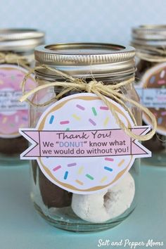 there is a jar with some donuts in it and a thank you tag on the top