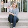 a woman sitting on steps with her arms crossed