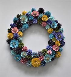 a wreath made out of pine cones and flowers