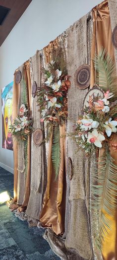 the curtains are decorated with flowers and foliages on them, along with decorative wall hangings