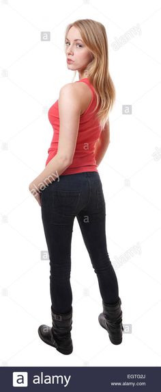 a young woman in black jeans and red tank top standing with her back to the camera