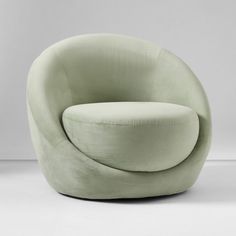 a green chair sitting on top of a white floor