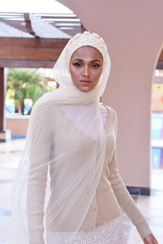 Complete your look with this stunning cream turban veil. Our Mystery in Cream Veil presents this magnificently embroidered turban to frame your face for a distinctive look. The one-piece turban veil is made especially for a simple yet classy fit that you can do yourself. The 58” long veil has a light cream shade to brighten up your dress.Whether it’s your wedding or engagement party, this turban veil will surprisingly shine up your special day and wow your guests.The turban's embroidery is based Elegant Cream Dupatta With Pearl Embroidery, White Headscarf For Wedding, Elegant White Headscarf For Wedding, Elegant White Wedding Headscarf, Elegant White Hijab For Eid, Fitted Headscarf For Wedding, Elegant Fitted White Turban, Elegant White Fitted Turban, Traditional White Hijab For Wedding