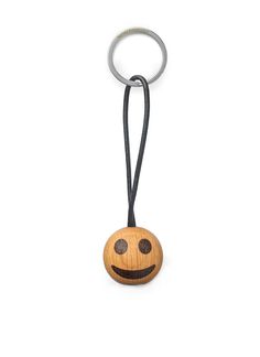 a wooden keychain with a smiley face on it