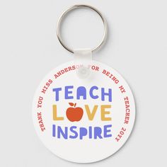 a keychain that says teach love inspire with an apple on the front and back