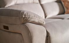 a close up view of the back end of a couch with pillows on top of it