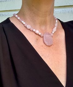 This stunning rose quartz and pearl pendant necklace is a true statement piece for any occasion. The delicate pink hues of the rose quartz are beautifully complemented by the lustrous pearls, creating a feminine and elegant look. This handcrafted necklace is perfect for adding a touch of romance and sophistication to your outfit. Treat yourself or a loved one to this exquisite piece of jewelry that is sure to be cherished for years to come. Select your desired necklace length from the drop down Rose Quartz And Pearl, Necklace Elegant, Rose Quartz Pendant, Rose Quartz Beads, Handcrafted Necklace, Pearl Pendant Necklace, Quartz Rose, June Birth Stone, Necklace Sizes