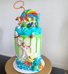 there is a birthday cake with toy figures on it