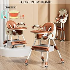 two baby high chairs sitting on top of a wooden floor