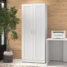 a white cabinet sitting next to a printer on top of a wooden floor in front of a wall