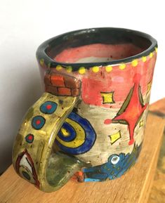 a ceramic cup sitting on top of a wooden table