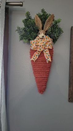 a carrot hanging on the wall with a bunny in it