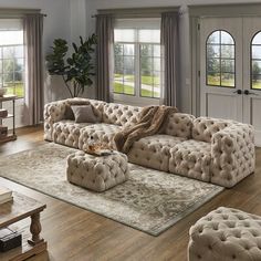 a living room filled with lots of furniture in front of two windows and a rug on the floor