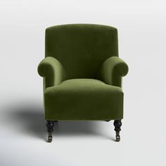 a green chair sitting on top of a white floor