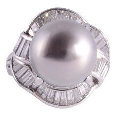 This is part of Chairish’s Fine Jewelry assortment.  Estate South Seas pearl platinum ring. This platinum ring features a 15-15.5mm South Seas pearl center that is a fine medium gray with a pinkish overtone. It is accented with 1.16 carat total weight of fine cut baguette diamonds having VS-SI clarity and G-H color. This South Seas pearl ring is a size 5.75, weighs 14.90 grams, and is appraised at $5,800. [ADTI 1012]  Metal: Platinum Stone: Diamond,South Sea Pearl Stone Cut: Baguette Cut Sea Rings, Marquise Diamond Ring, Golden South Sea Pearls, Pearl And Diamond Ring, Platinum Diamond Rings, Baguette Diamonds, Sea Pearl, Modern Ring, South Seas