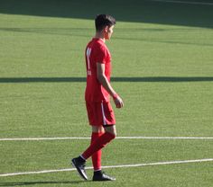 a soccer player is standing on the field