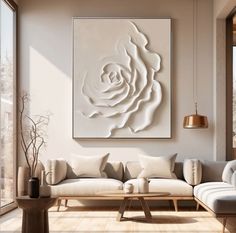 a living room filled with furniture and a large white rose on the wall above it