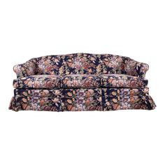 a blue floral couch with ruffles on the arms and back, against a white background