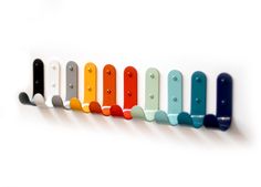 a row of different colored plastic objects on a white surface