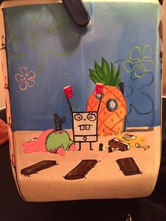 a painting on the side of a bag with an image of a pineapple and other items