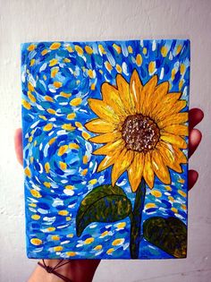 a painting of a yellow sunflower on a blue background