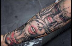 a woman's arm with two faces and red lipstick on it, as well as the