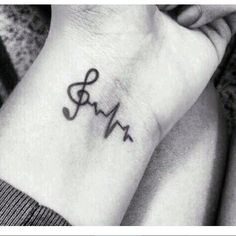 a small heartbeat tattoo on the wrist