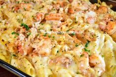 a casserole dish with shrimp and pasta in it, ready to be eaten