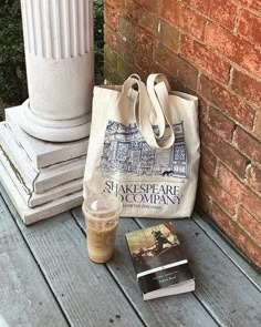 a tote bag sitting on top of a wooden table next to a cup of coffee