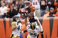 two football players jumping up in the air