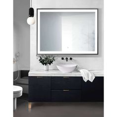 a bathroom vanity with a large mirror above it and a white bowl on the counter